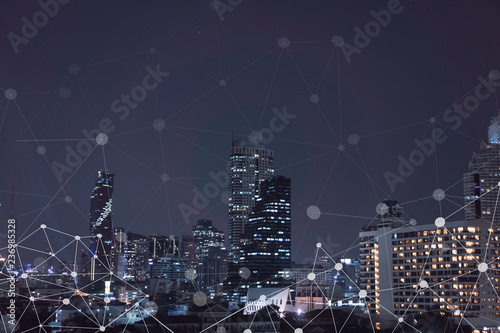 Smart city with internet of things and wireless communication network connection on abstract of modern building night light Bangkok Thailand background
