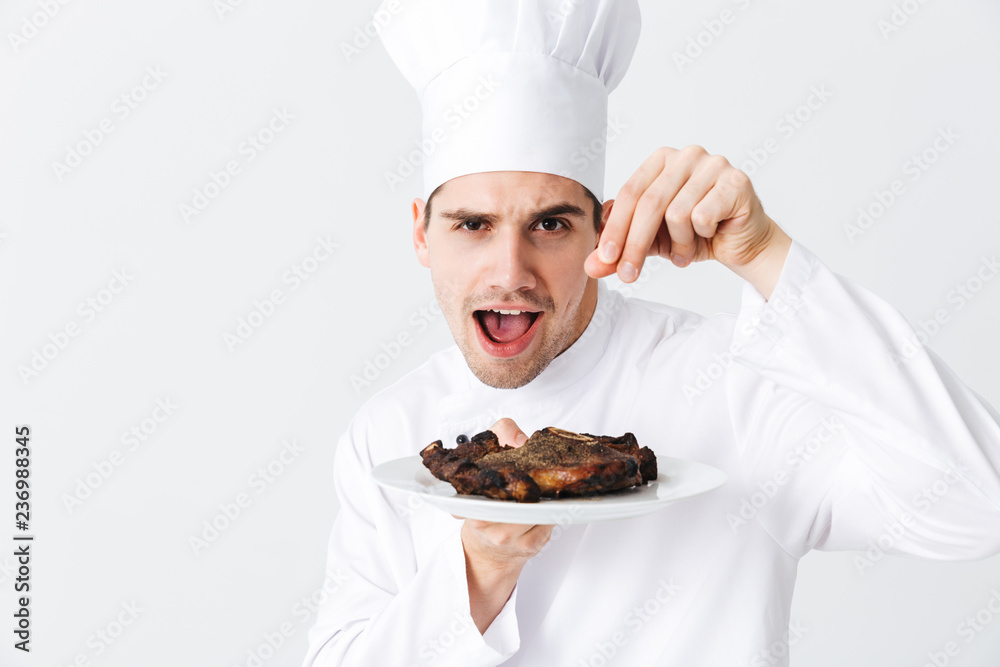 Cheerful chef cook wearing uniform peppers Cheerful chef cook wearing uniform peppers