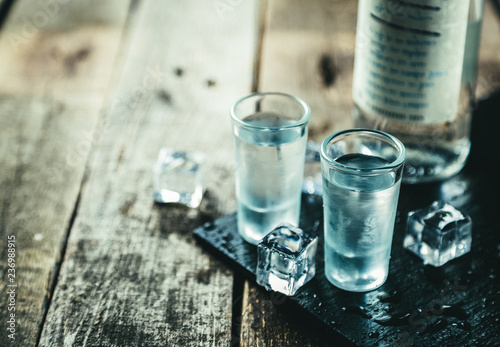 Fotografie, Obraz Traditional greek vodka - ouzo in shot glasses