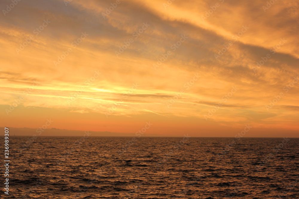 Sunset Sky Landscape Over Calm Sea Water with Vibrant Orange Cloudscape. Beautiful Sky Background at Sunset or Sunrise, Dusk and Dawn Panoramic Skyline View with Still Water on Summer Season Image