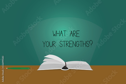 Writing note showing What Are Your Strengthsquestion. Business photo showcasing Tell us your best qualities skills Color Pages of Book on Table with Pen and Light Beam Glaring