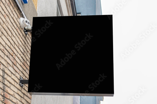 Mock up of blank black rectangular signboard on the wall photo