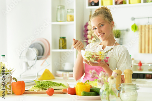 Portrait of girl in the kitchen preparing to eat