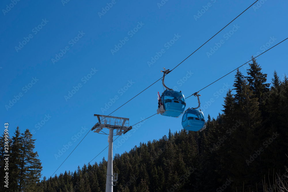 Gondola cable car in the Bansko with a beautiful mountain summer landscape and fir trees