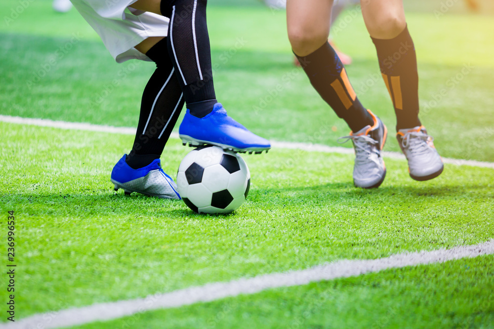 Kid soccer players trap and control the ball for shoot to goal. Kid soccer players trap and control the ball for shoot to goal.