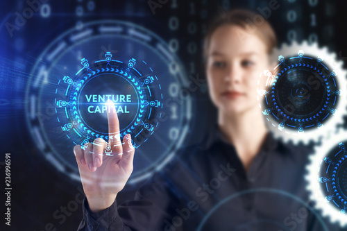 The concept of business, technology, the Internet and the network. A young entrepreneur working on a virtual screen of the future and sees the inscription: Venture capital