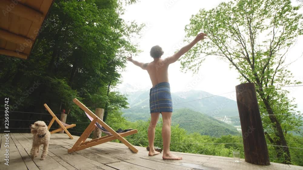 young man is rejoicing at great nature, mountaines, forest. ispiration, pleasure, muse enjoyment concept young man is rejoicing at great nature, mountaines, forest. ispiration, pleasure, muse enjoyment concept
