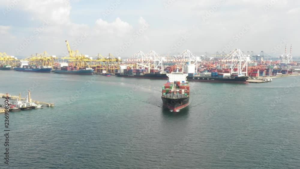 Container ship in export and import business and logistics. Shipping cargo to harbor by crane. Water transport International. Aerial view and top view. Container ship in export and import business and logistics. Shipping cargo to harbor by crane. Water transport International. Aerial view and top view.
