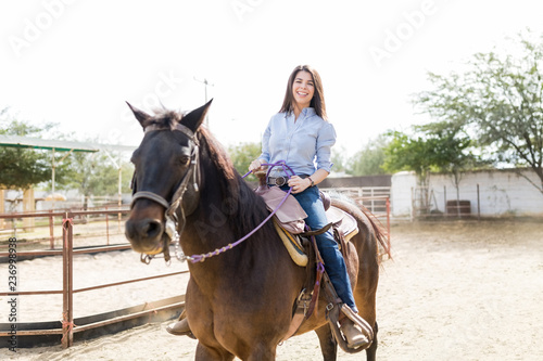 Rancher Smiling While Riding Brown Horse