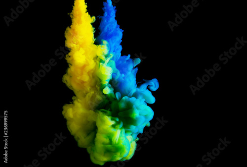 paint stream in water, colored cloud, abstract background, process of mixing multicolored dye on a black background