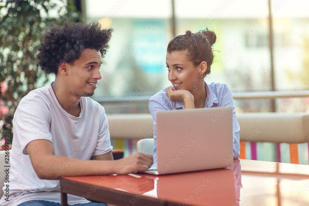 Two freelance working in coffee shop, Nomad worker conceptual, couple work together in cafe with laptop Two freelance working in coffee shop, Nomad worker conceptual, couple work together in cafe with laptop