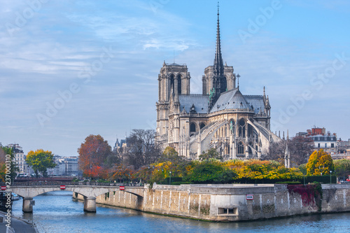 Cathedral of Notre Dame de Paris sunny autumn afternoon. Embankment of the Seine River. The natives and tourists take a walk and relax in warm weather. Blurred, unrecognizable faces. Paris. France.