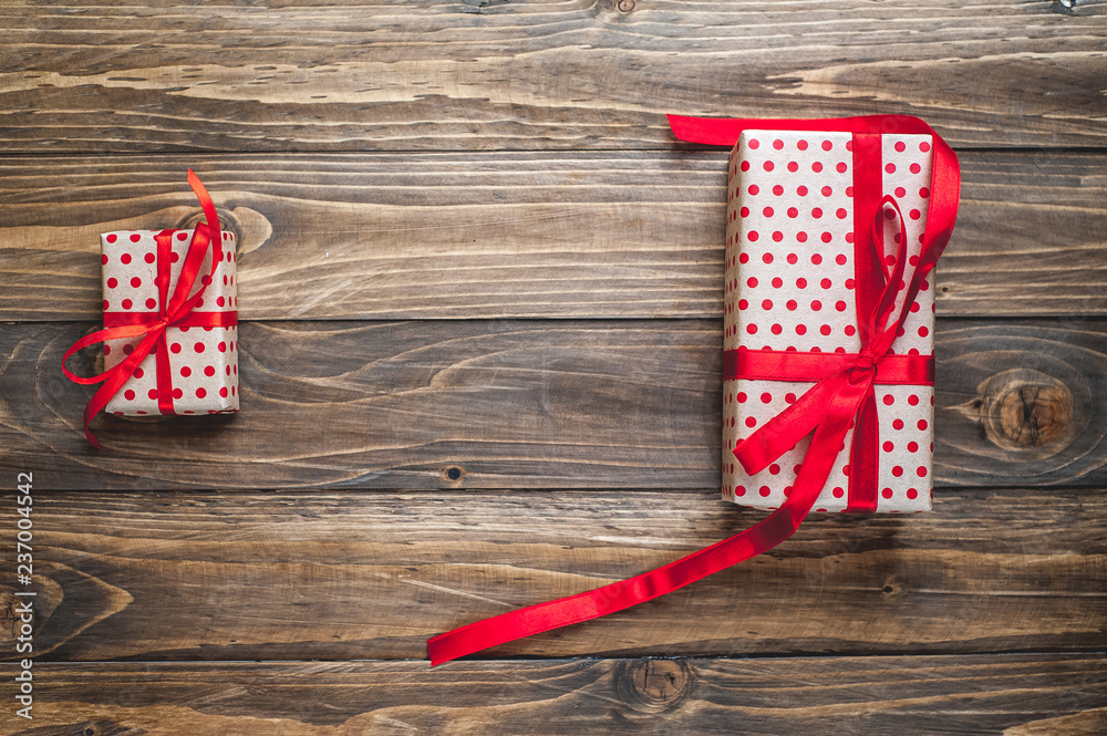 Fototapeta premium gift boxes with red ribbon on wooden table