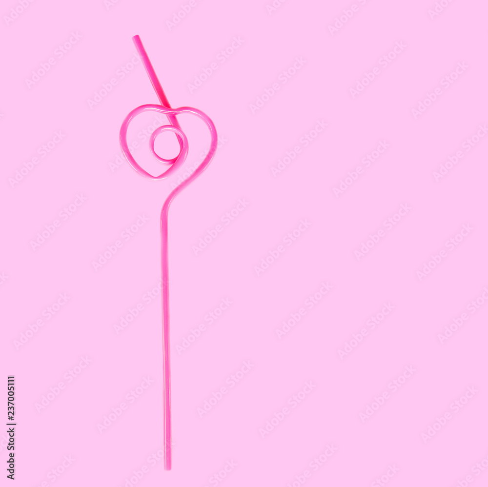 pink straw in the shape of a heart for a cocktail isolated on a pink background pink straw in the shape of a heart for a cocktail isolated on a pink background