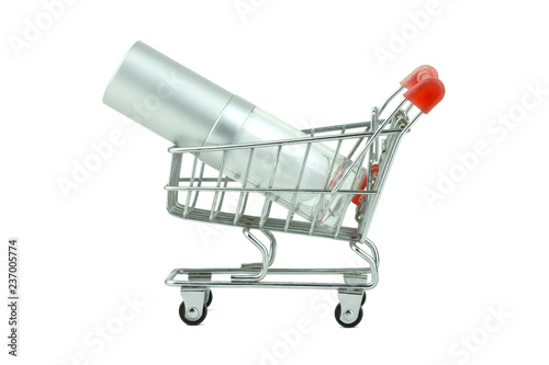 Concept idea shopping, empty a bottle of face cream in miniature shopping cart, isolated with clipping path on white background. © DesignStory