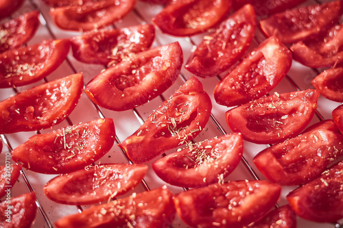 Preparing dried tomatoes  laying of sliced tomatoes  selective focus