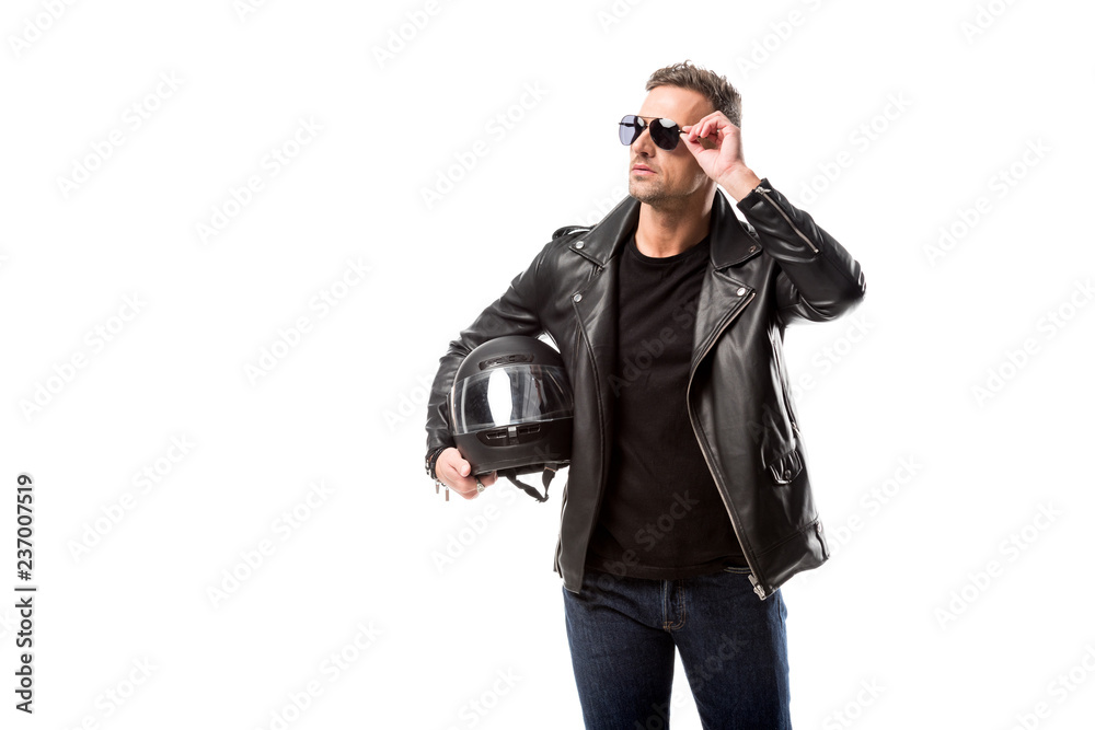 man in leather jacket and sunglasses holding motorcycle helmet and posing isolated on white man in leather jacket and sunglasses holding motorcycle helmet and posing isolated on white