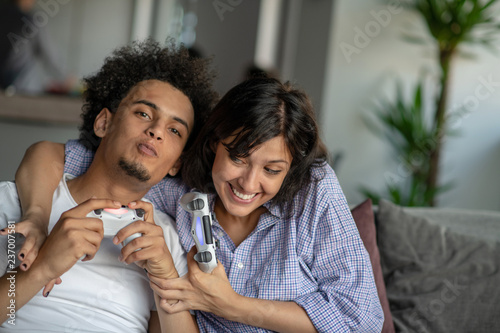 Young couple enjoying playing video games together.