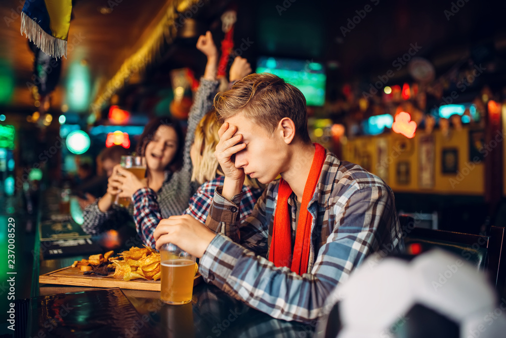 Upset football fan at the counter in sports bar