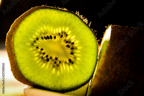 slice of kiwi on black background