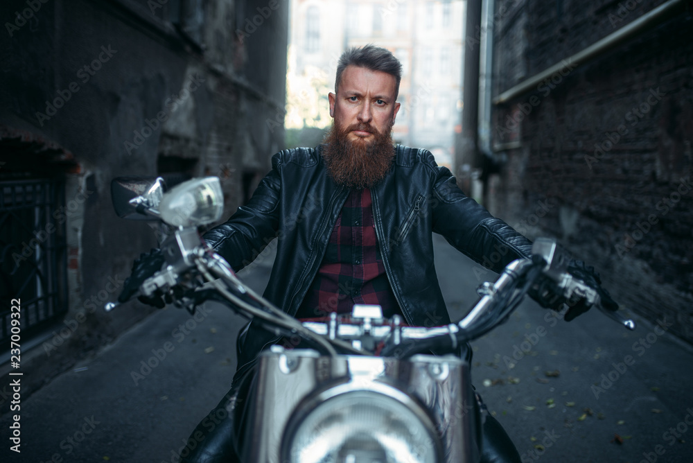 Fototapeta premium Bearded biker on classical chopper, front view