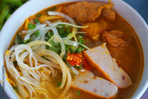  Bun Cha Ca - Delicious grilled catfish fish caked noodles Da Nang signature dish Vietnamese food Asian cuisine with red green chilly herb tomato onion lettuce spinach tomato pork stock  photo