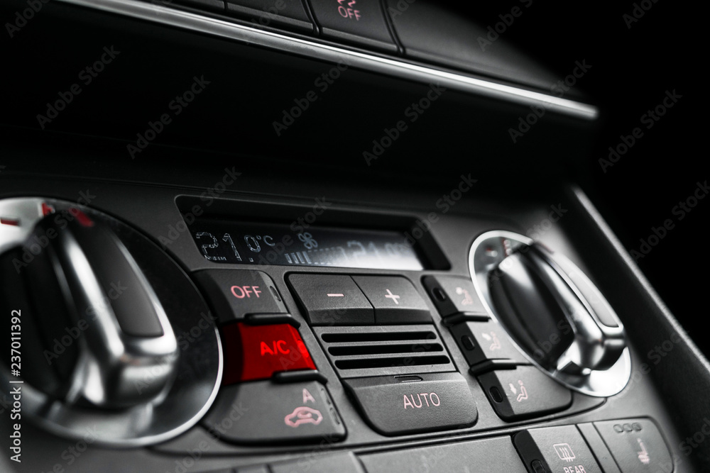 Air conditioning button inside a car. Climate control AC unit in the new car. Modern car interior details. Car detailing. Car inside