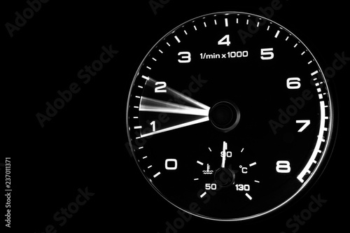 Close up shot of a speedometer in a car. Car dashboard. Dashboard details with indication lamps.Car instrument panel. Dashboard with speedometer, tachometer, odometer. Car detailing. Modern interior. 