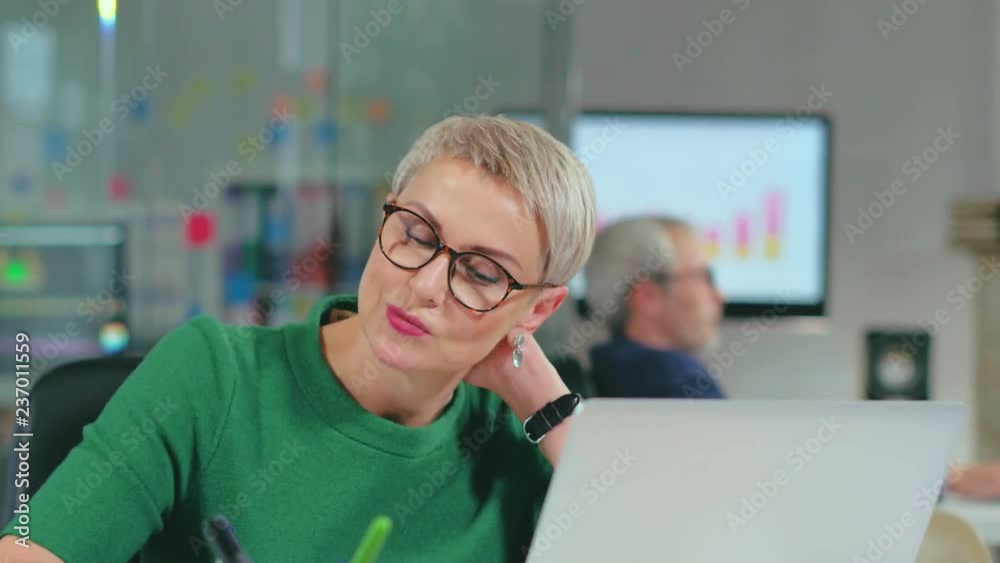 Concentrated middle-aged european businesswoman working Concentrated middle-aged european businesswoman working