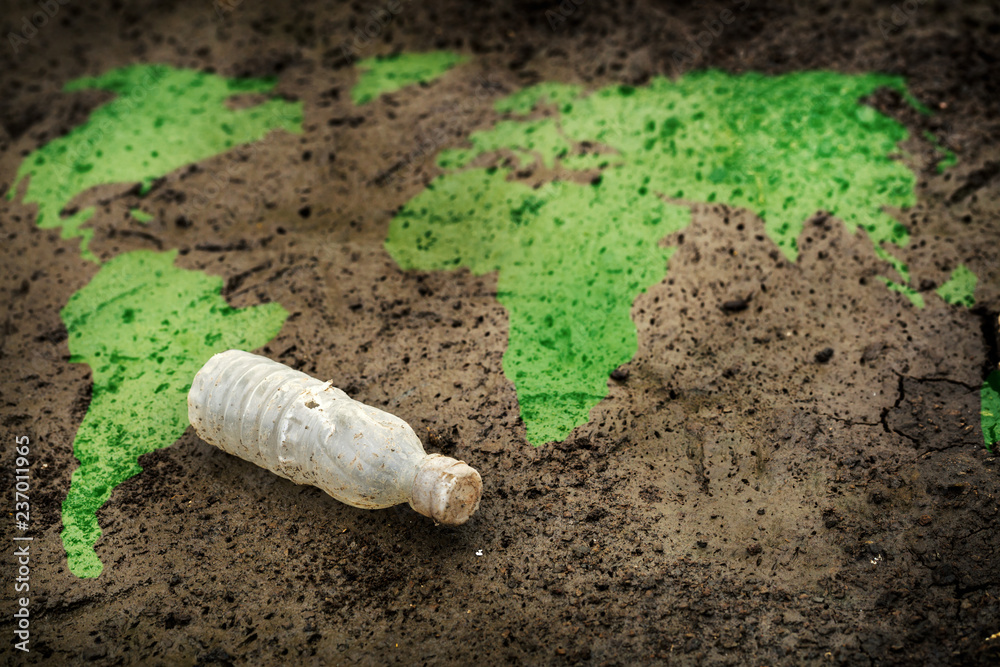 One Waste is already too much for our Earth Concept, Green World Map and an Old Plastic Bottle on Earth One Waste is already too much for our Earth Concept, Green World Map and an Old Plastic Bottle on Earth