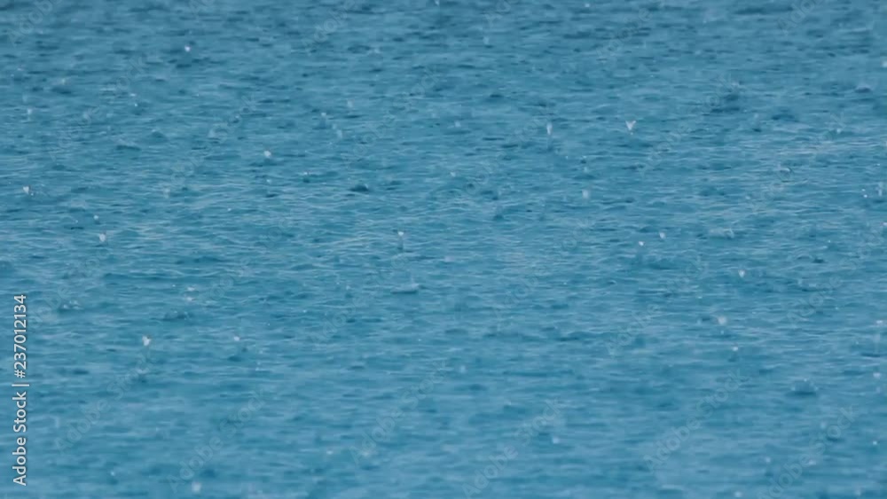 Heavy rain falls into a swimming pool. Sound of rain falling. Heavy rain falls into a swimming pool. Sound of rain falling.