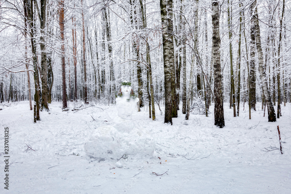 Snowman in winter forest