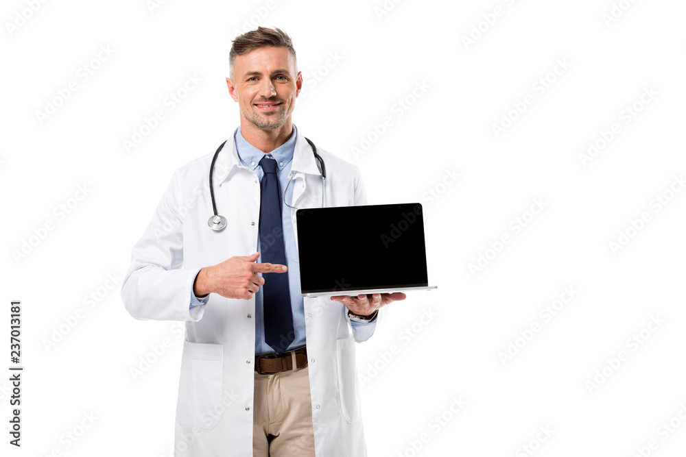 handsome doctor pointing at laptop with blank screen isolated on white handsome doctor pointing at laptop with blank screen isolated on white