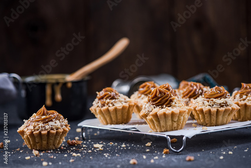 Homemade satled caramel cupcakes on tray photo