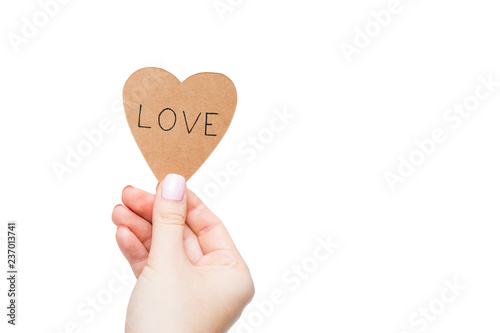 Craft sticker with inscription love in woman's hand on white background. Isolated on white. Hand holding sticker. Template photo