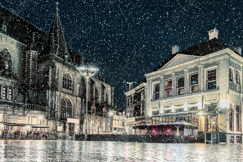 Winter view with snowfall of the Dutch central square in the city of Zwolle photo