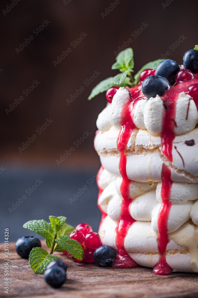 Pavlova with fresh berry fruits,mint and strawberry sauce