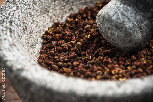 Obraz na plátně Timut sihuan pepper seeds in granite pestle or mortar