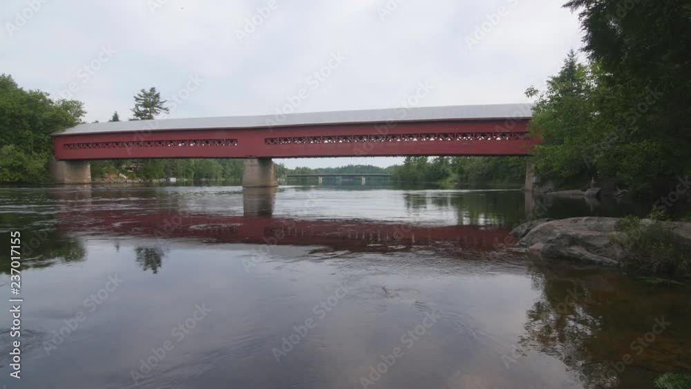 Wooden covered bridge and Gatineau river in Wakefield, Quebec. Wooden covered bridge and Gatineau river in Wakefield, Quebec.