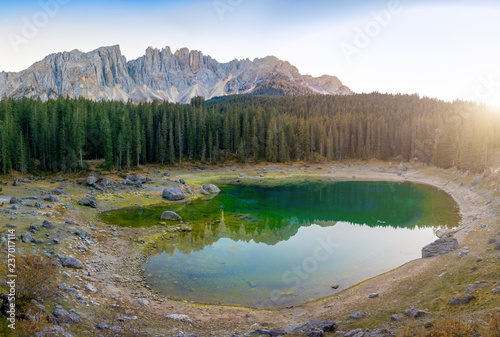 Karersee or Lago di Carezza  is a lake with mountain range of the Latemar group on background in the Dolomites in Tyrol  Italy