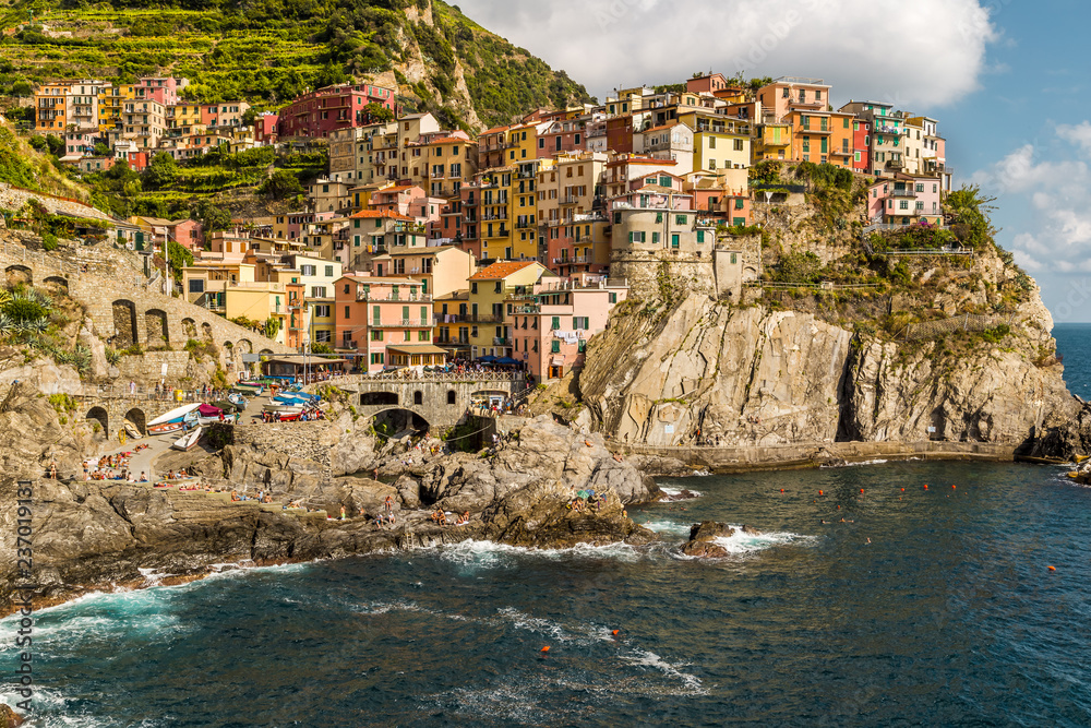 Colorful houses on a rocky hill over Mediterranean sea at Manarola, Cinque Terre, Italy