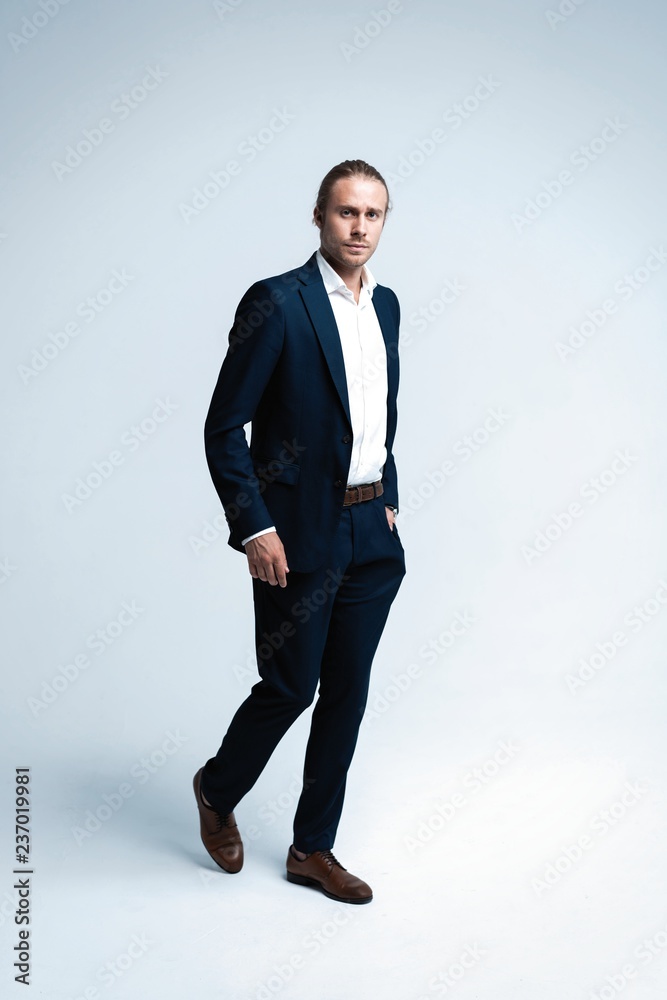 Perfect suit. Full length of handsome young man in suit looking at camera while standing against white background Perfect suit. Full length of handsome young man in suit looking at camera while standing against white background