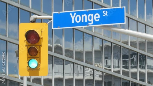 Yonge Street street sign with stoplight. Toronto, Canada. Heatshimmer. Light turns from green to red.