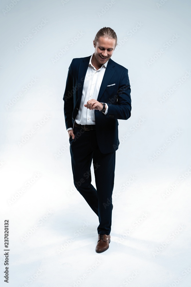 Perfect suit. Full length of handsome young man in suit looking at camera while standing against white background Perfect suit. Full length of handsome young man in suit looking at camera while standing against white background