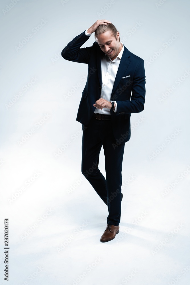 Perfect suit. Full length of handsome young man in suit looking at camera while standing against white background Perfect suit. Full length of handsome young man in suit looking at camera while standing against white background