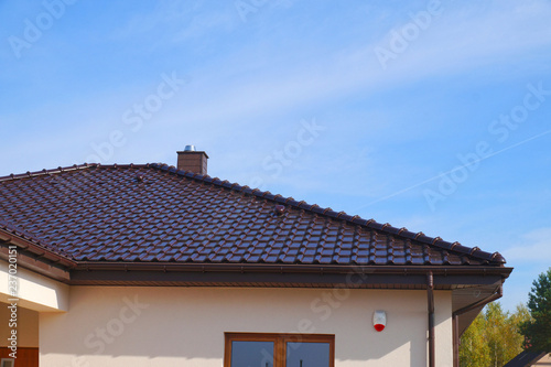 A newly built residential house. A fragment of the roof made of ceramic tiles.