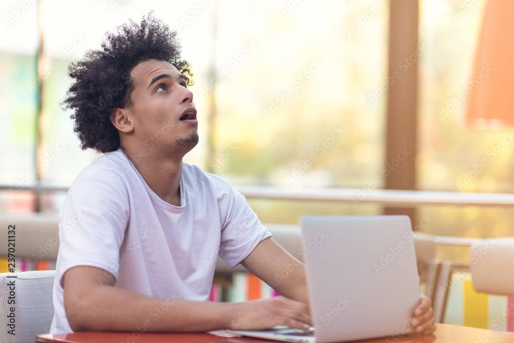 Image of african american businessman working on his laptop. Handsome young man at his desk. Image of african american businessman working on his laptop. Handsome young man at his desk.
