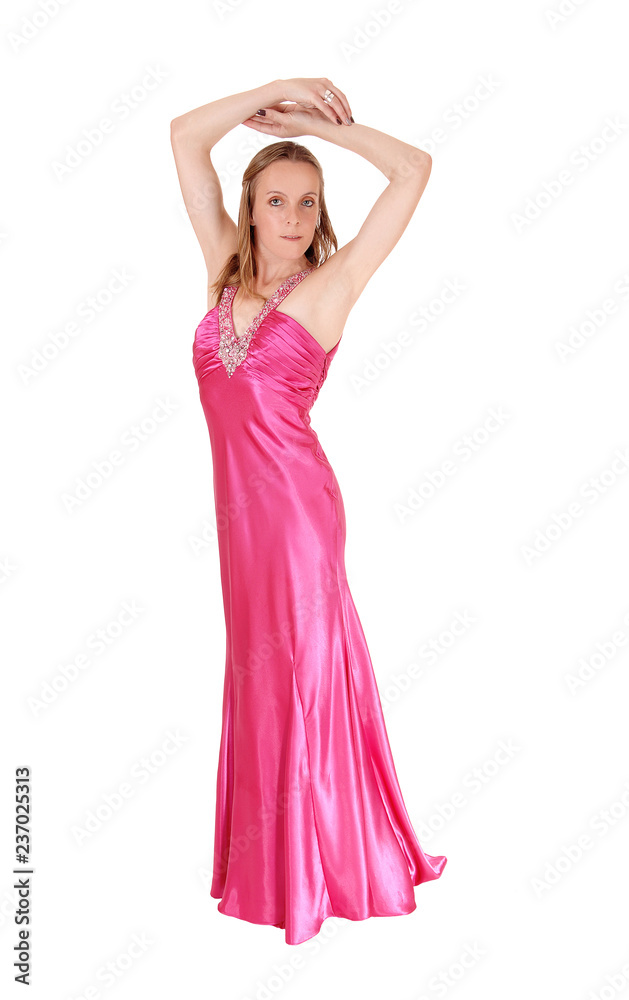 Woman standing in an pink evening gown