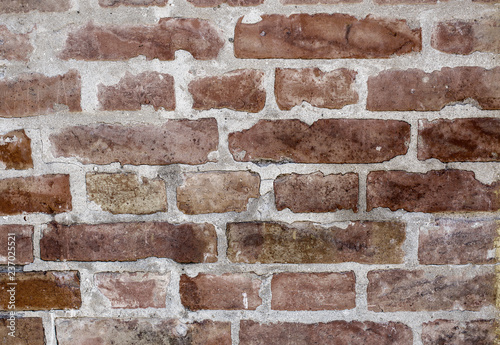 Weathered stained old brick wall background. Rough brick wall. Toned