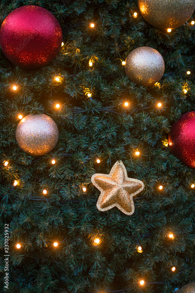 Christmas tree decorated with sparkly ornaments and lights Christmas tree decorated with sparkly ornaments and lights